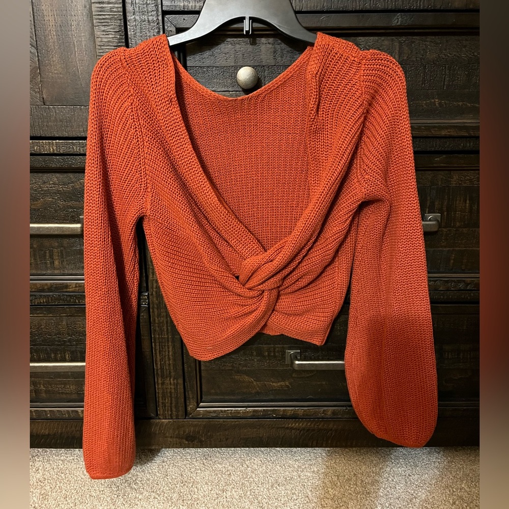 Lulu’s cropped burnt orange sweater.